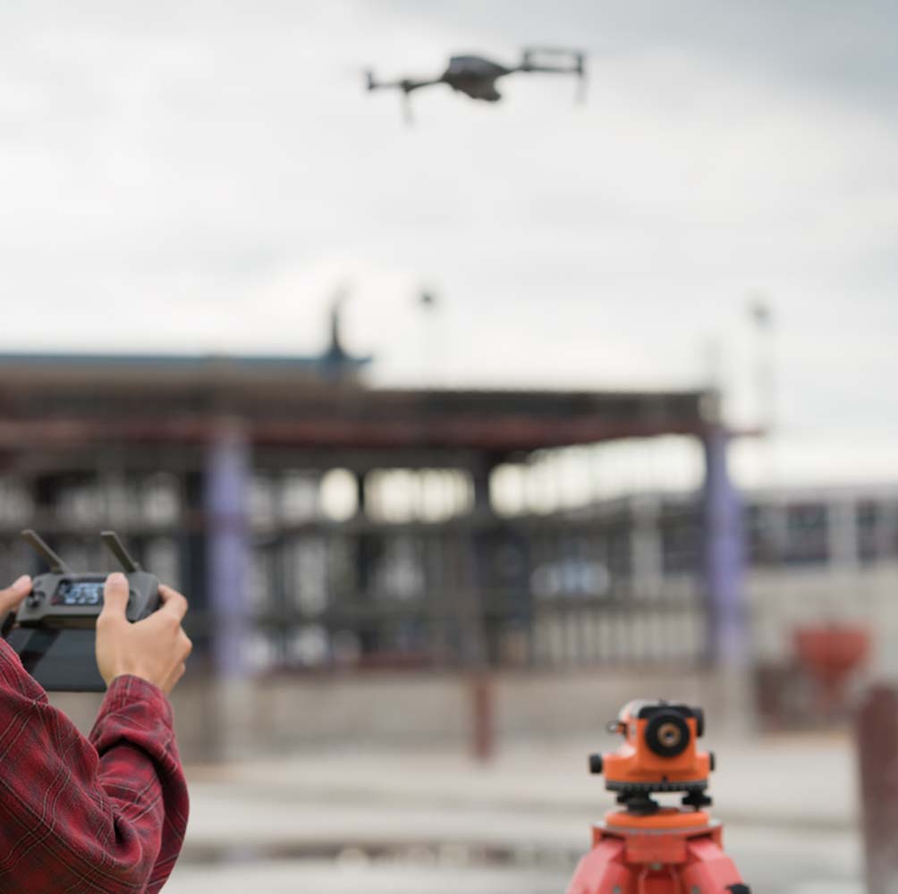 Engineer surveyor working with drone at construction site